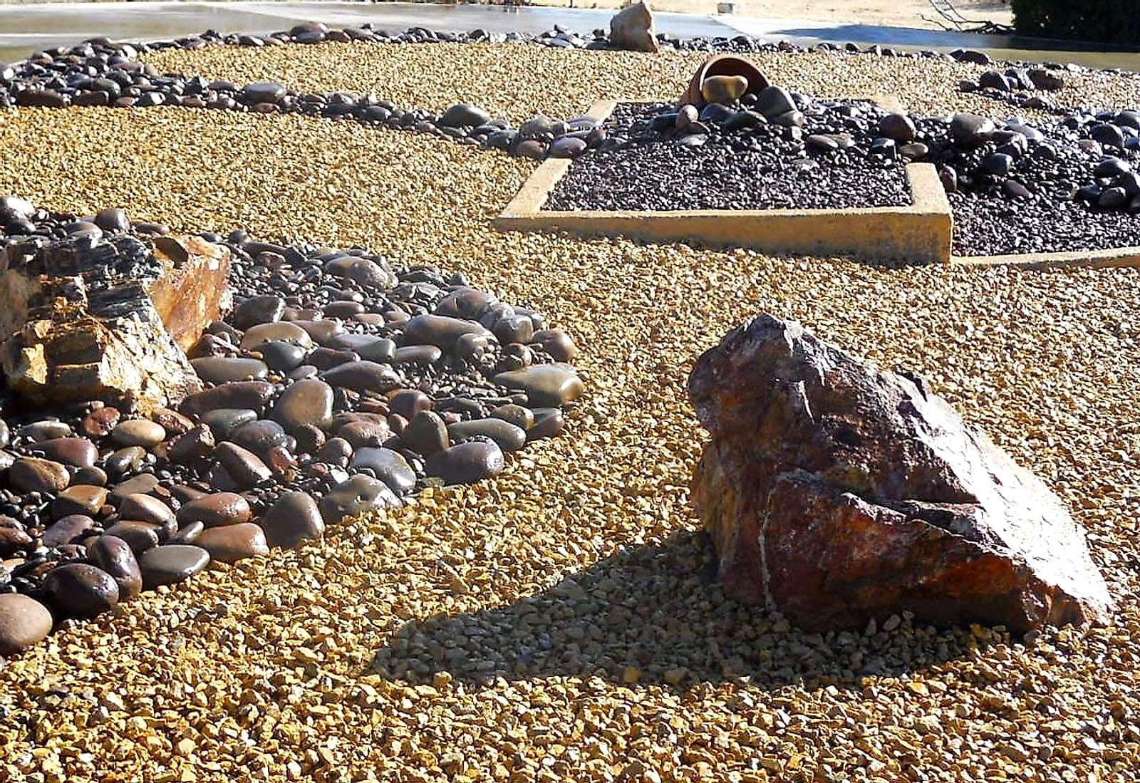 Large boulders and river cobble set in gold gravel