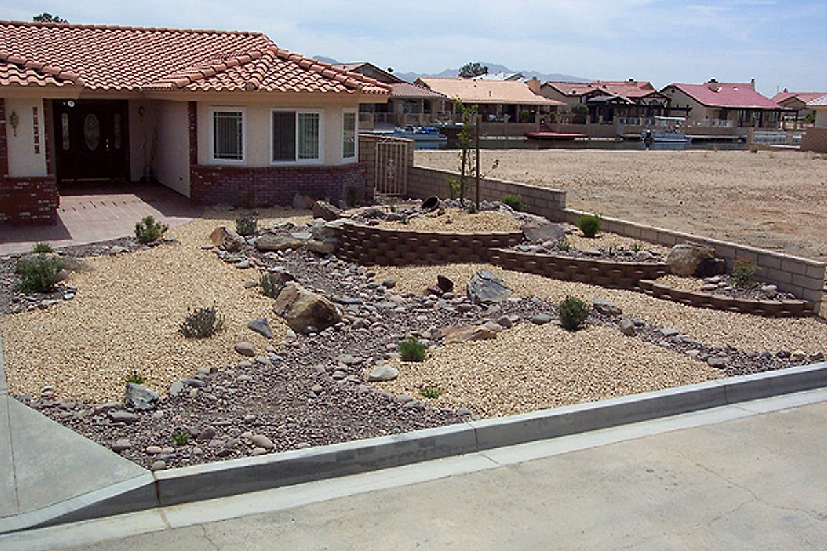 Gravel front yard with block wall planters