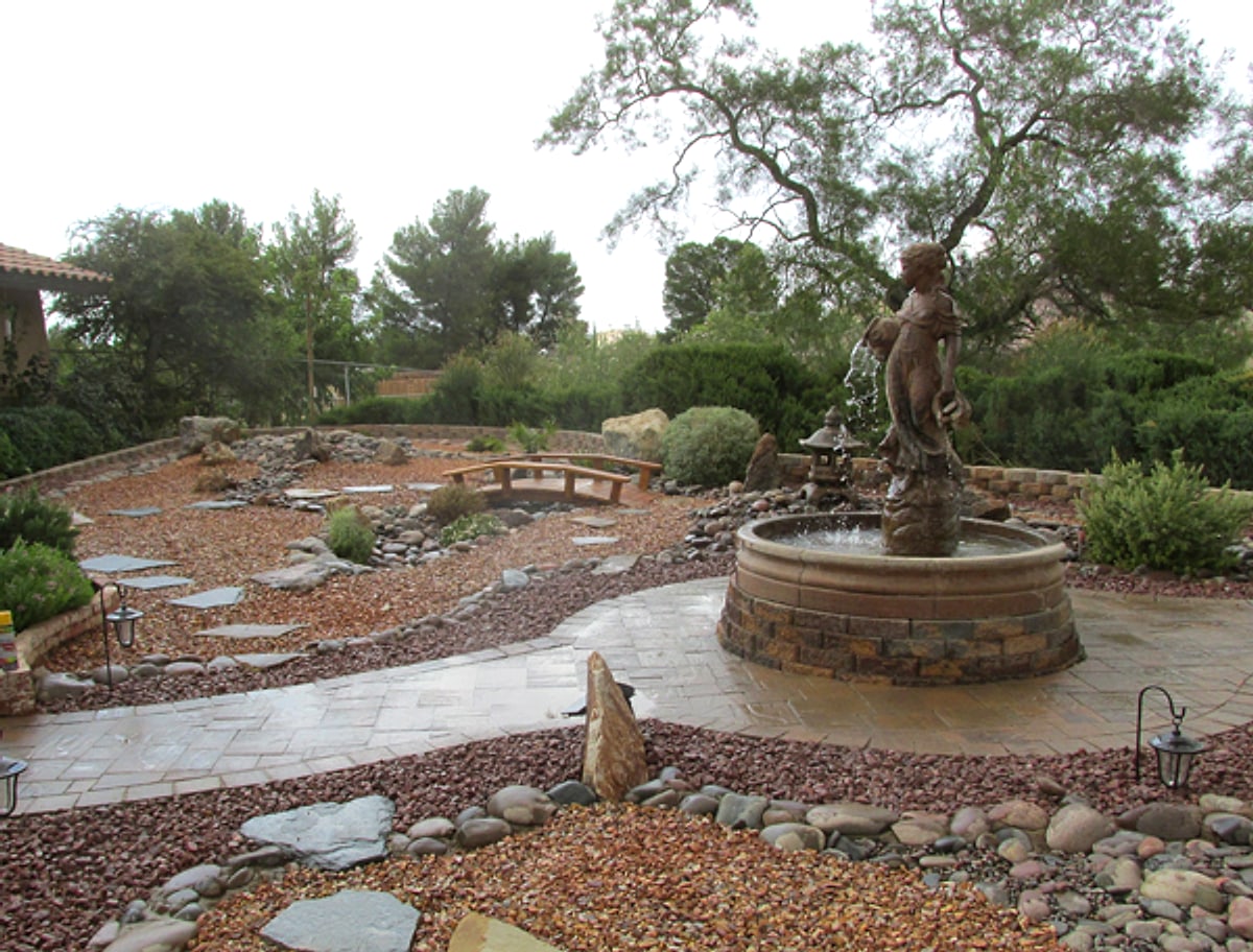 Courtyard with a statue fountain, flagstone and red rock